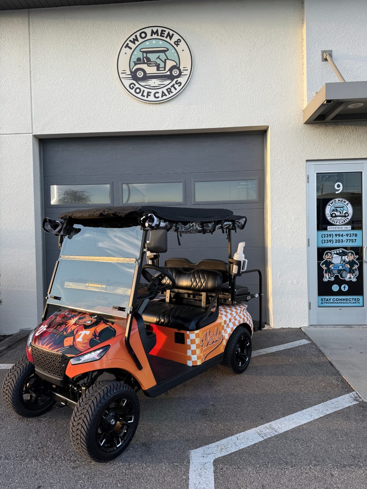 Orange and white Tennessee Vols themed lifted golf cart